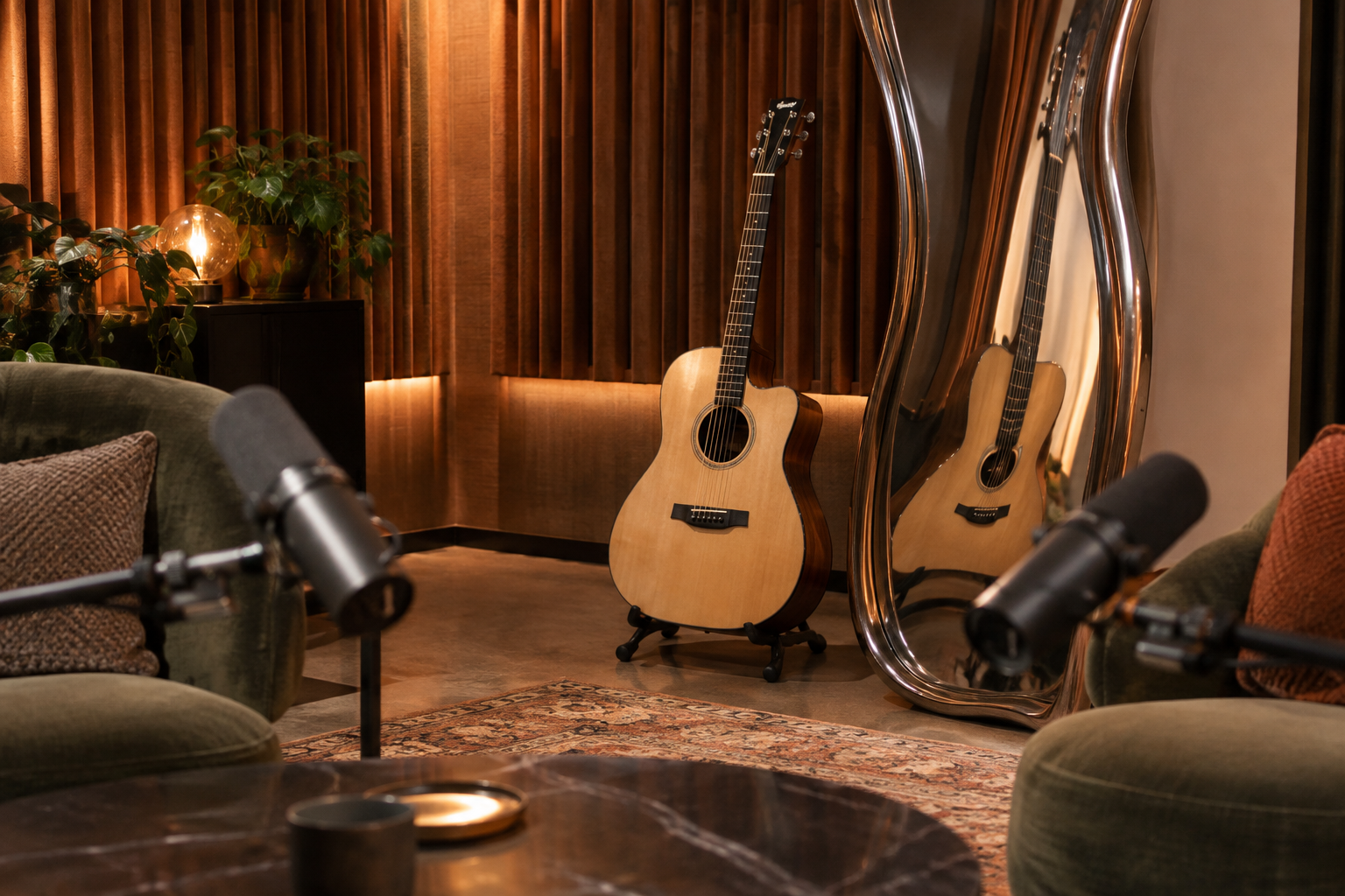 An acoustic guitar beside a curved mirror that stretches its reflection, with two microphones in an empty podcast studio.